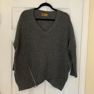 Dark grey sweater with zipper on right side.